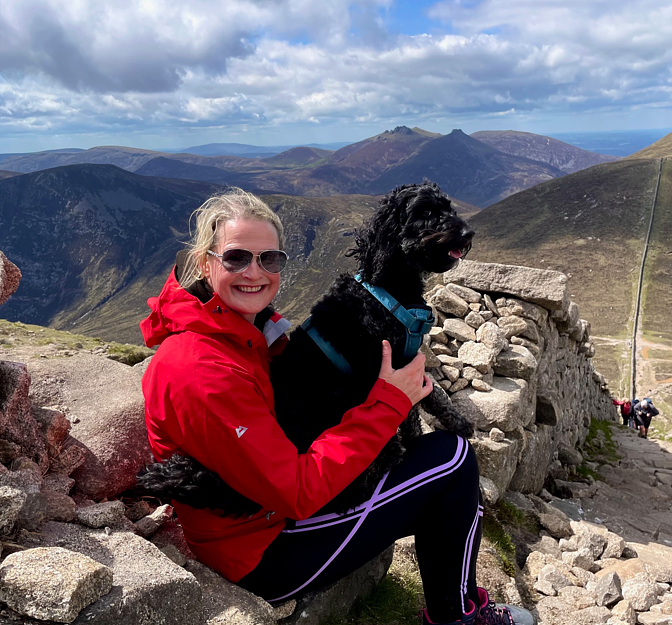 Dearbhaile with her dog at the top of a mountain