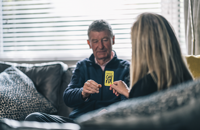 Person handing over Cancer Card